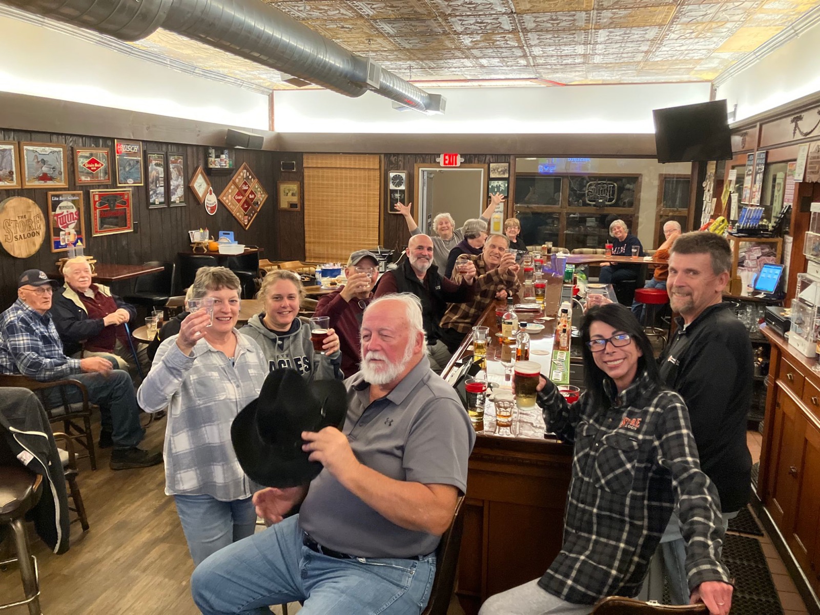 Regulars raising a toast at the bar